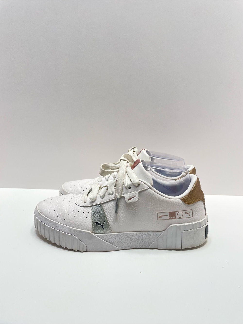 Women’s 7.5 Puma Cali Hacked White with gold and silver accents